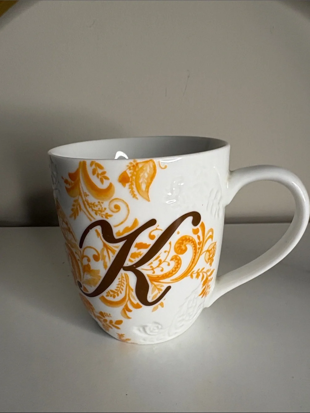Pier 1 White Mug with Orange and Brown Flourish and 'K' Monogram